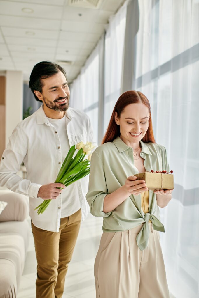 Couples gift exchange in modern living room